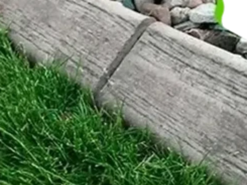 Wood-grain concrete border beside lawn and stone